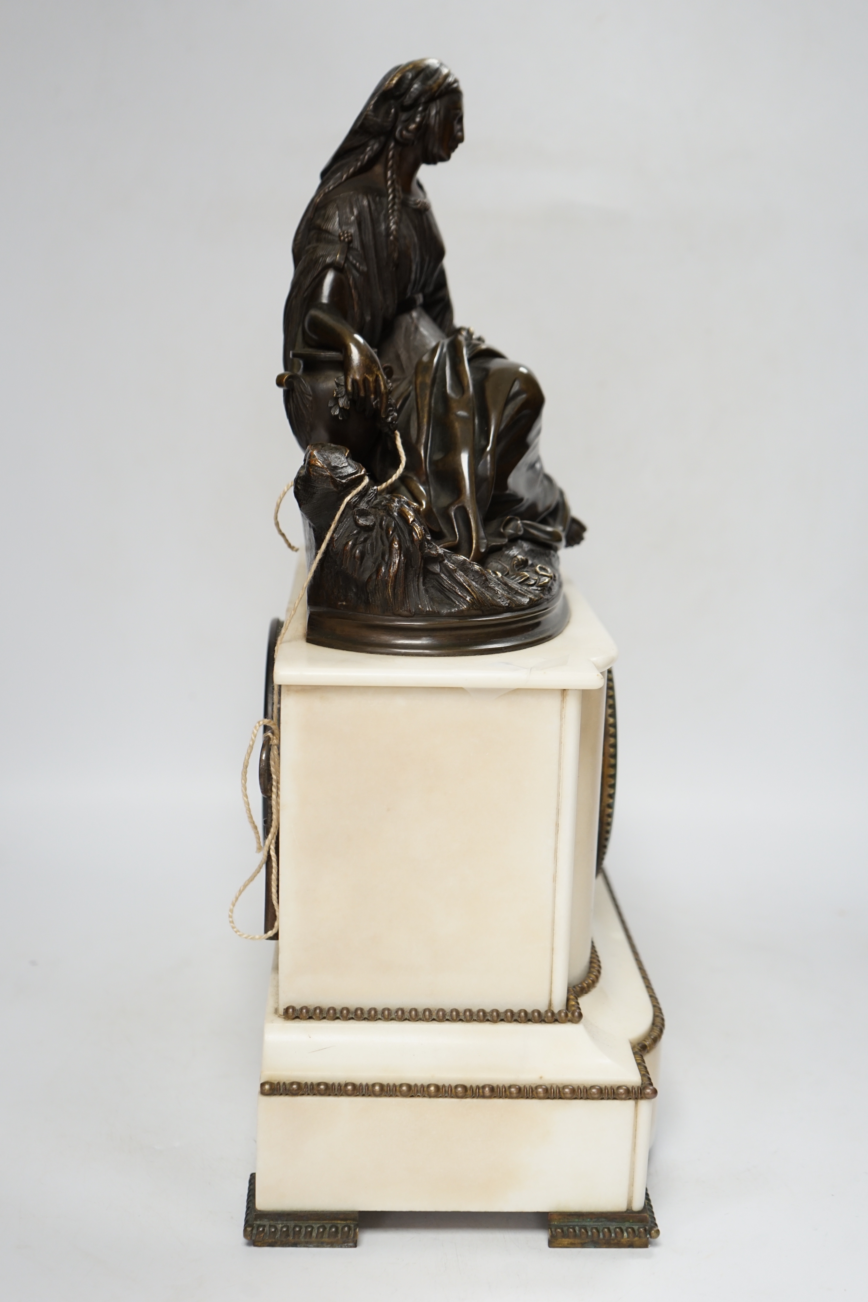 A late 19th century French figural bronze mounted white marble mantel clock, 42cm